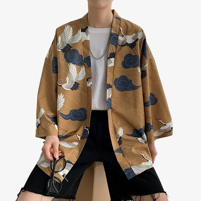 A Japanese man is dressed in a haori yukata kimono jacket made from cotton and polyester. The kimono jacket is printed with Japanese Tsuru cranes and Kumo Japanese cloud symbols.