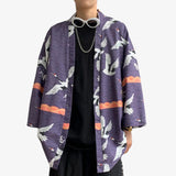 A Japanese man is wearing a Tokyo Haori. Tsuru motifs are imprinted on the blue cotton fabric of the kimono jacket.