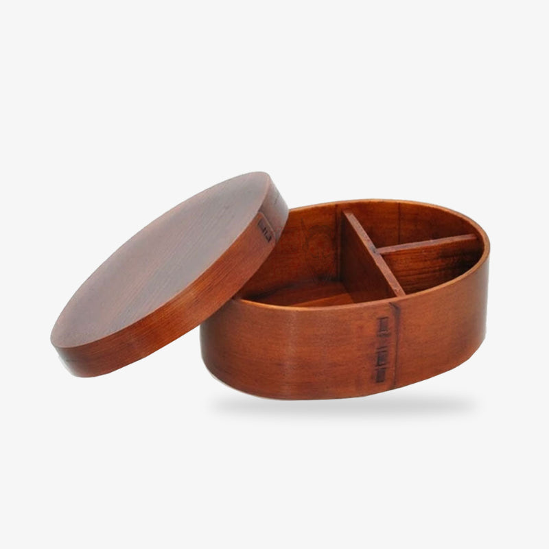 Wooden traditional bento box meal​ with a lid on a white background