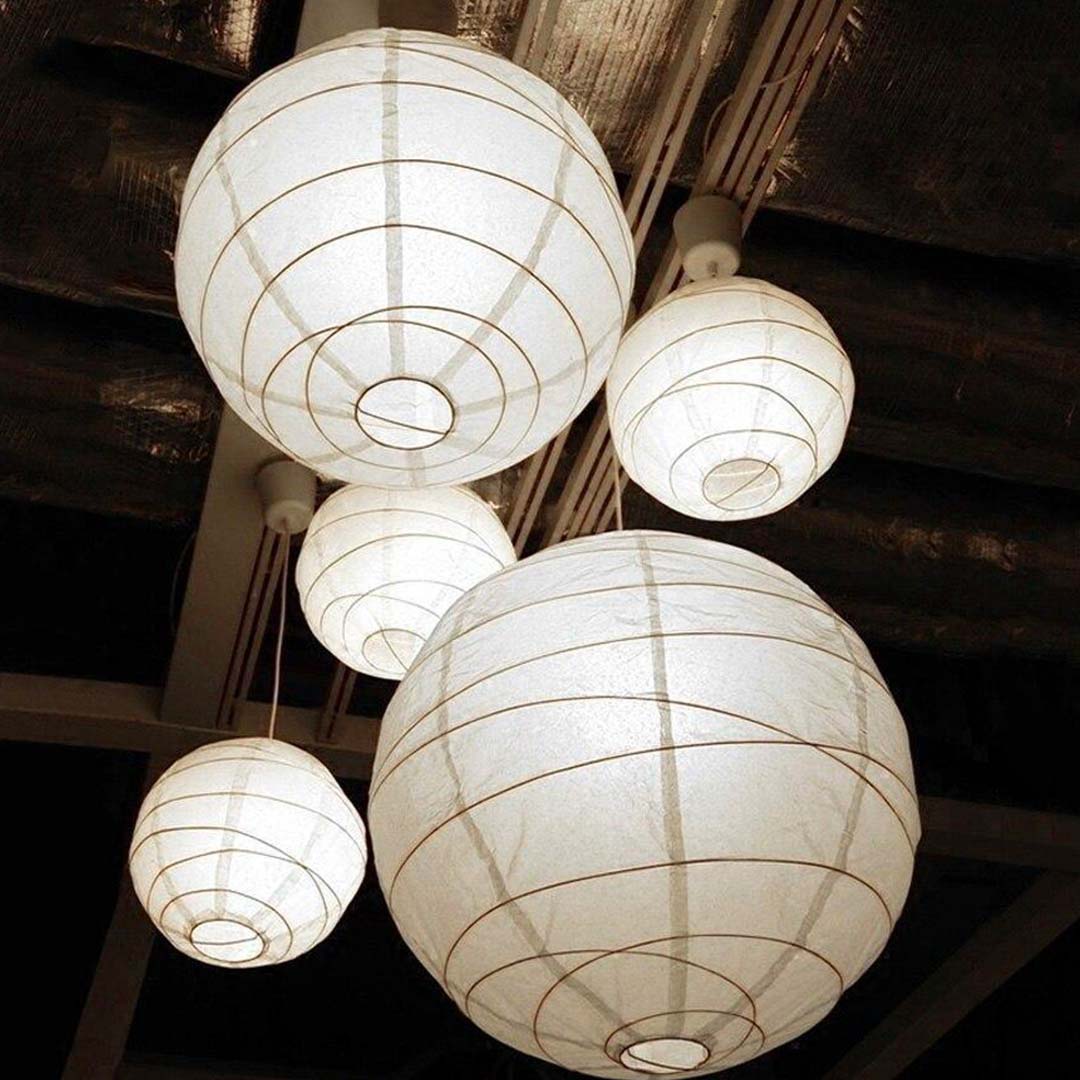 The white paper lanterns are traditional Chochin lanterns made from high-quality paper and bamboo, offering a minimalist and elegant lighting solution for any space.